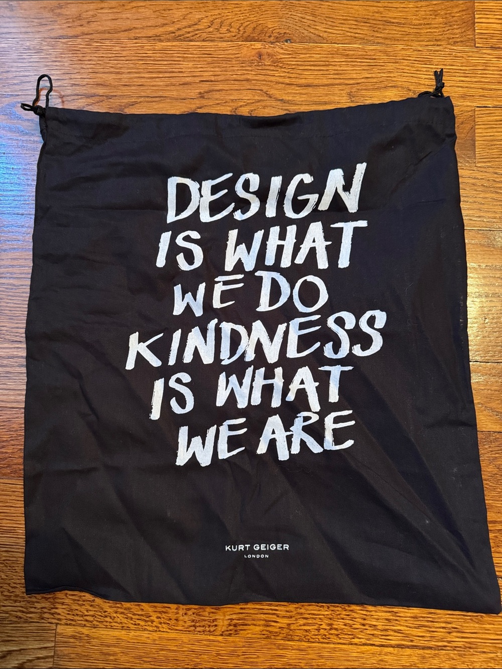 Kurt Geiger Black Drawstring Bag with White Slogan
